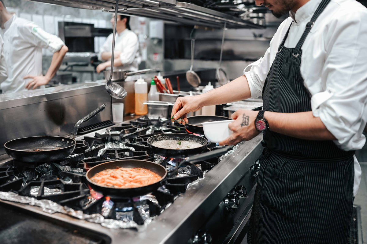 Chefs working a busy commercial kitchen line