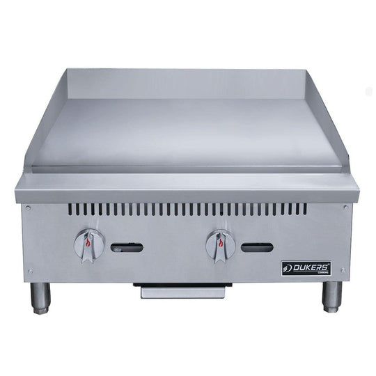 Dukers DCGM24 gas griddle angled view showing polished steel cooking plate and grease trough