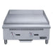 Dukers DCGM24 gas griddle angled view showing polished steel cooking plate and grease trough