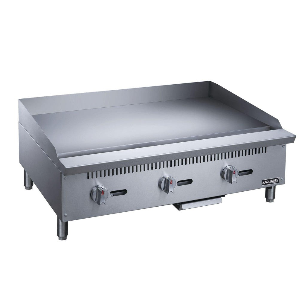 Dukers DCGMA36 36 inch manual gas griddle with three burner controls and 1 inch polished steel plate