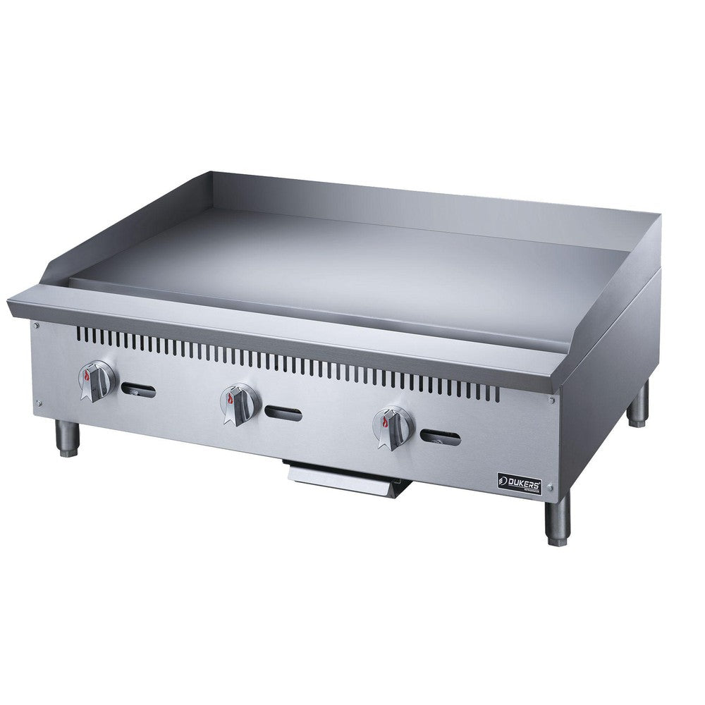 Dukers DCGMA36 gas griddle angled view showing deep cooking surface and splash guard