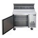 Dukers DPP44 pizza prep table with the door open showing the interior shelf and cabinet