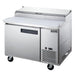 Side view of the Dukers DPP44 pizza prep table showing the cutting board depth and caster mounting