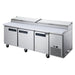 Dukers DPP90 pizza prep table with doors open showing three refrigerated sections and wire shelves