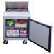 Dukers DSP29-8-S1 prep table with full-depth poly cutting board in use